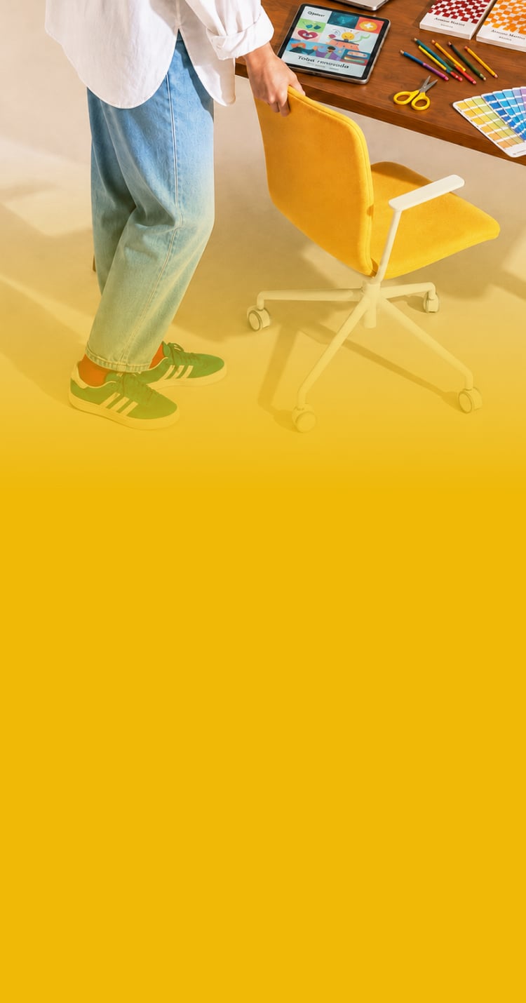 Designer setting up a workspace with a yellow chair